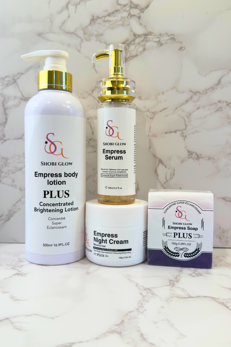 Shobi Glow Empress Set including lotion, serum, cream, and soap on a marble background